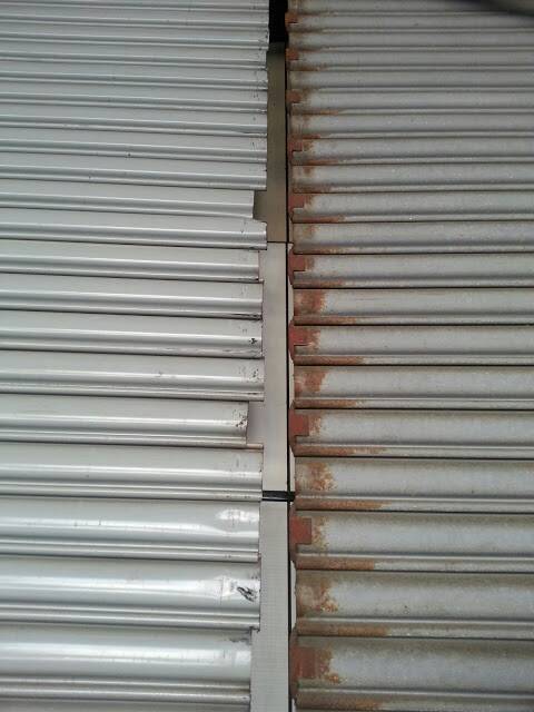 電動捲門，門片擋片沒焊，導致不整齊，會卡住